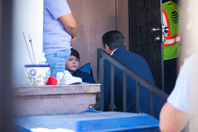 <em>Carvalho at his second home visit in Boyle Heights. Above, the student and his mother.</em>