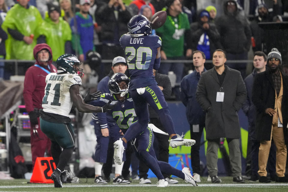 Seattle Seahawks safety Julian Love (20) makes an interception on a pass intended for Philadelphia Eagles wide receiver A.J. Brown (11) during the second half of an NFL football game, Monday, Dec. 18, 2023, in Seattle. The Seahawks won 20-17. (AP Photo/Lindsey Wasson)