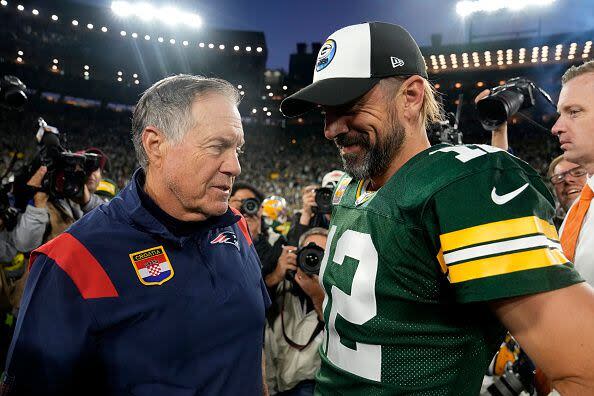 GREEN BAY, WISCONSIN - OCTOBER 02: Head coach Bill Belichick of the New England Patriots and Aaron Rodgers #12 of the Green Bay Packers talk after Green Bay's 27-24 win in overtime at Lambeau Field on October 02, 2022 in Green Bay, Wisconsin. (Photo by Patrick McDermott/Getty Images)