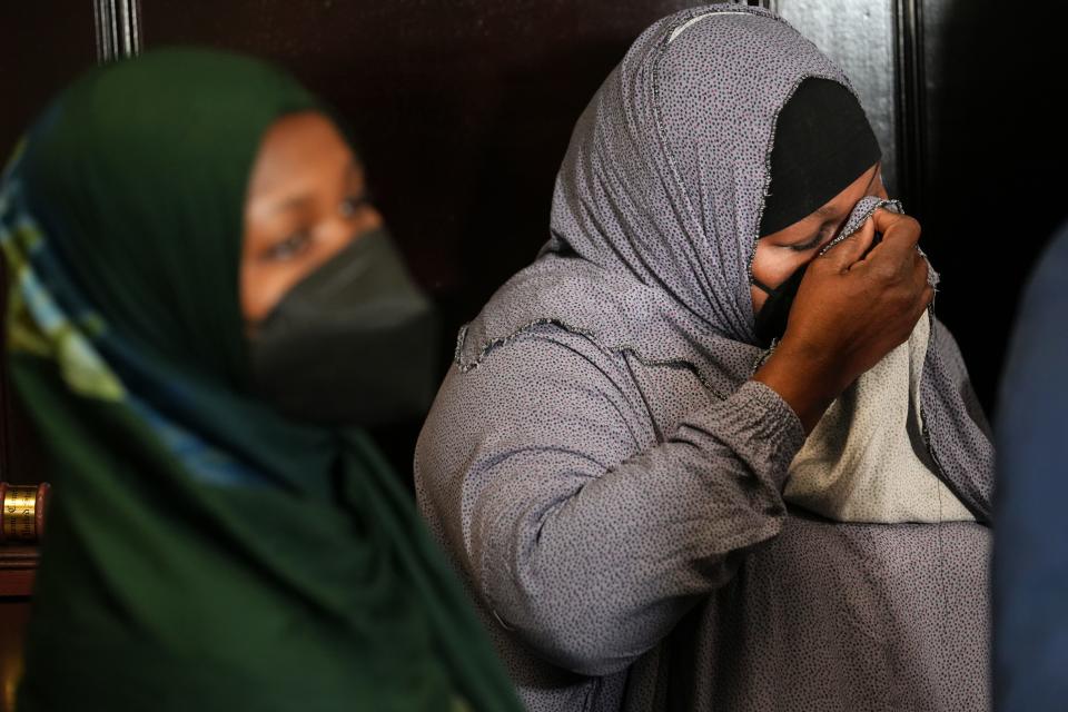 Halima Osman, right, the sister of Ali Osman, who was killed by Phoenix police, wipes away tears as she stands with Ali's niece Ikran Aden during a news conference on Thursday, Sept. 29, 2022.