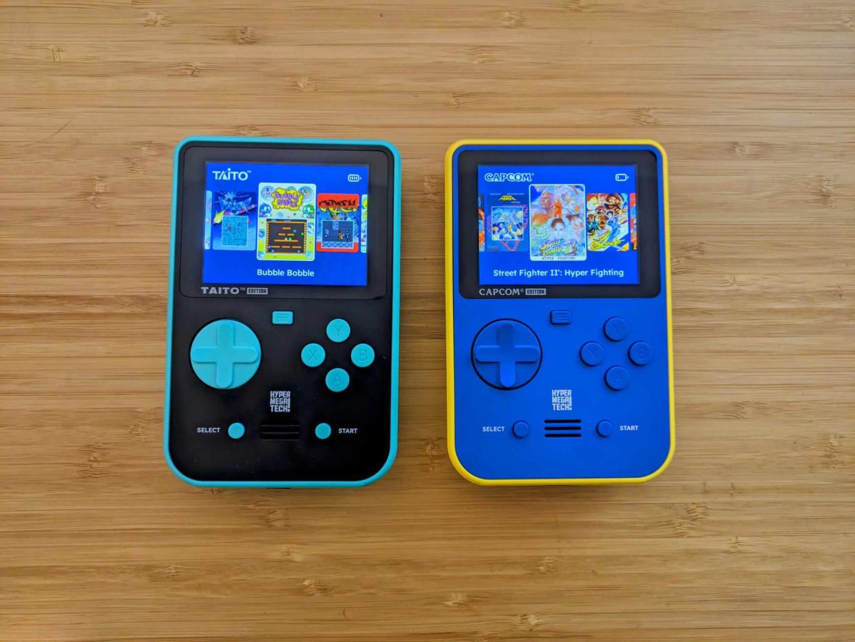  Super Pocket review; two colourful retro consoles on a wooden table. 