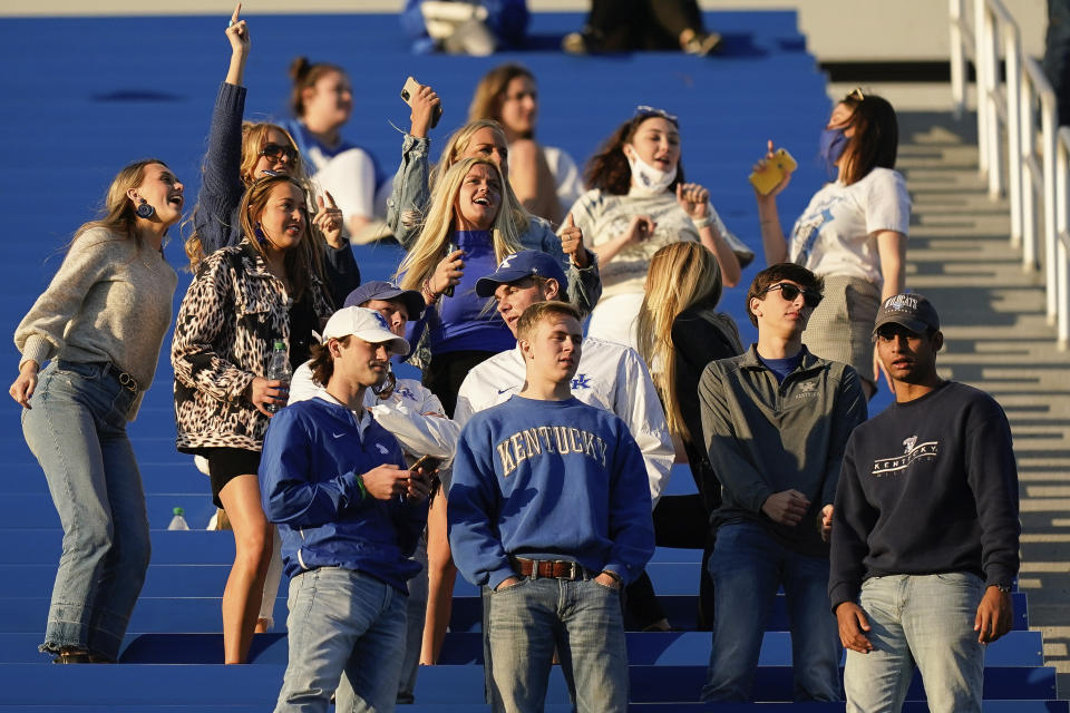 FILE - In this Oct. 3, 2020, file photo, Kentucky fans cheer during the second half of an NCAA college football game against Mississippi, in Lexington, Ky. Coaches wearing masks around their chins. Fans not wearing masks at all while cheering from their seats. One school deciding to drop the safety checks it was requiring for those entering the stadium to cut down on long lines. College football is sending plenty of alarming signals at it attempts to get through a tenuous season amid a pandemic. (AP Photo/Bryan Woolston, File)