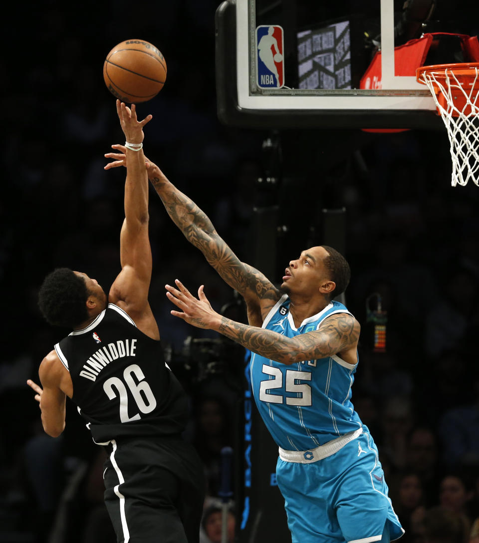 Brooklyn Nets guard Spencer Dinwiddie (26) shoots over Charlotte Hornets forward P.J. Washington Jr. (25) during the first half of an NBA basketball game, Sunday, March 5, 2023, in New York. (AP Photo/John Munson)