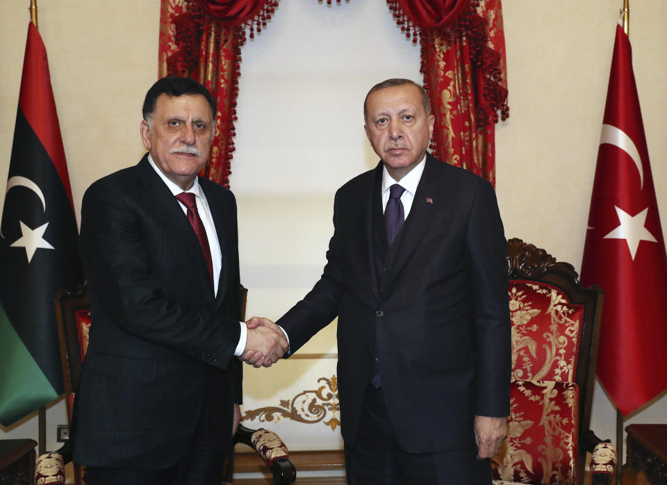 Turkey's President Recep Tayyip Erdogan, right, shakes hands with Fayez al Sarraj, the head of Libya's internationally recognised government, prior to their talks in Istanbul, Sunday, Dec. 15, 2019. Turkey and Libya had reached an agreement on the delineation of maritime boundaries in the Mediterranean, in November. (Turkish Presidency via AP, Pool)