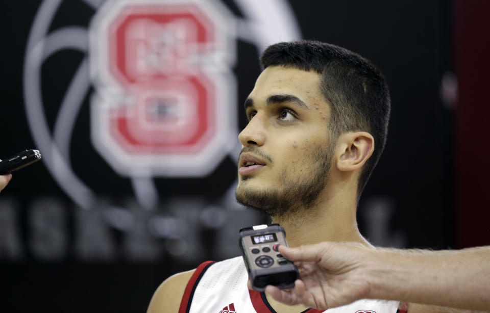 North Carolina State’s Omer Yurtseven takes questions during the NCAA college basketball team’s media day in Raleigh, N.C., Tuesday, Sept. 26, 2017. (AP Photo/Gerry Broome)