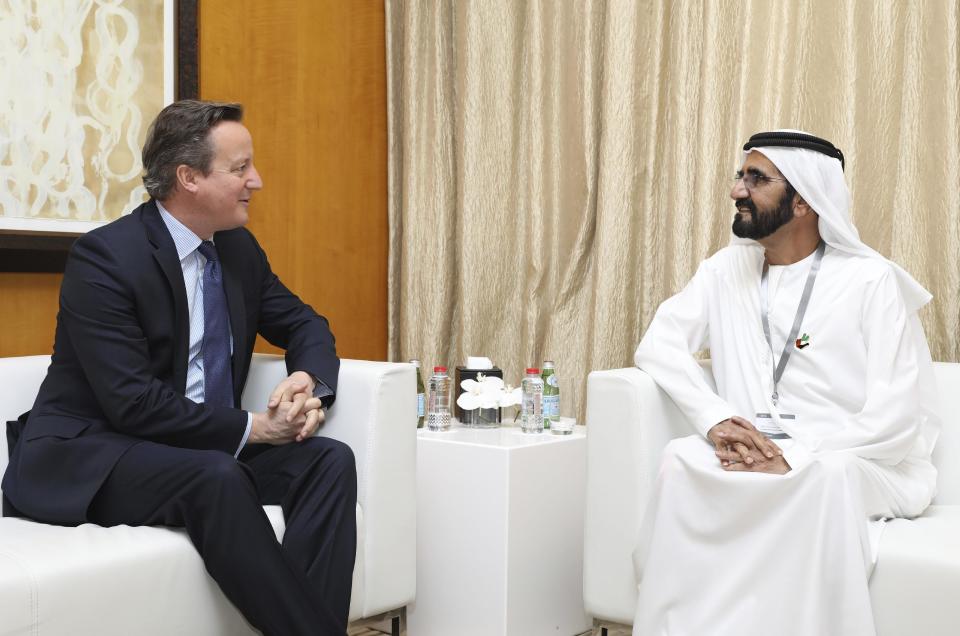 In this photo, released by Emirates News Agency, WAM, Sheikh Mohammed bin Rashid Al Maktoum, UAE prime minister and ruler of Dubai, right, talks to David Cameron, former Prime Minister of the United Kingdom, during the opening day of Arab Strategy Forum in Dubai, United Arab Emirates, Wednesday Dec. 14, 2016. A former CIA director and Cameron offered simple advice on Wednesday for U.S. President-elect Donald Trump: Have daily intelligence briefings.(Emirates News Agency via AP)