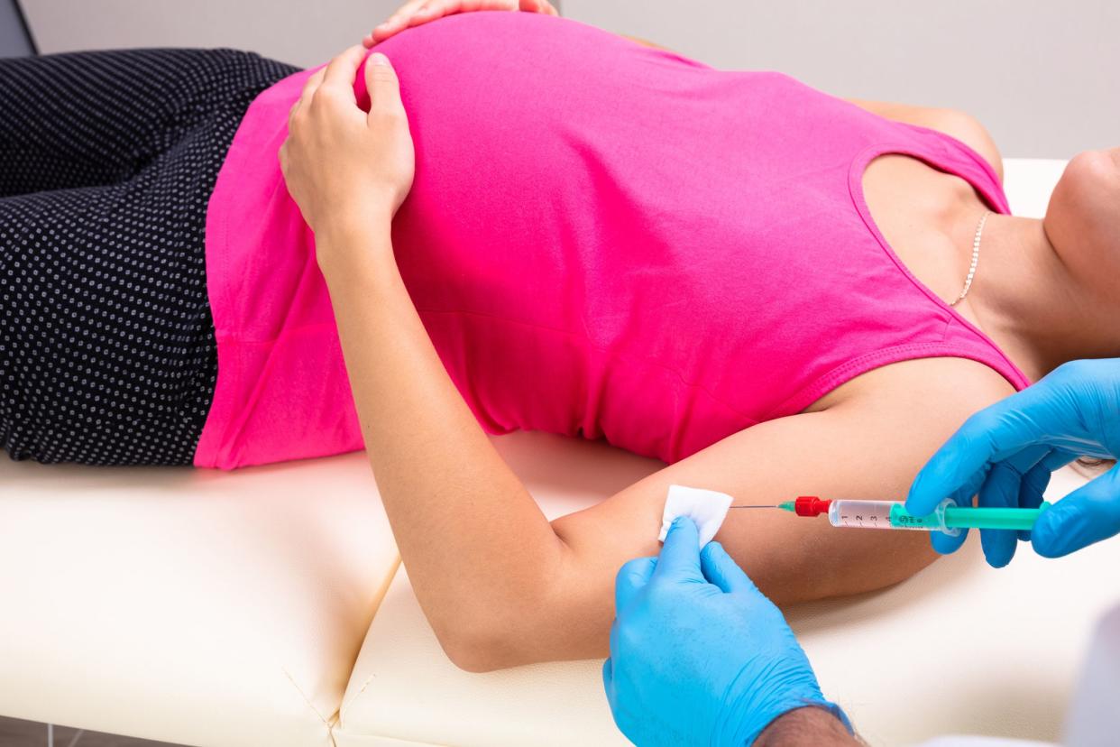 pregnant woman receiving flu shot