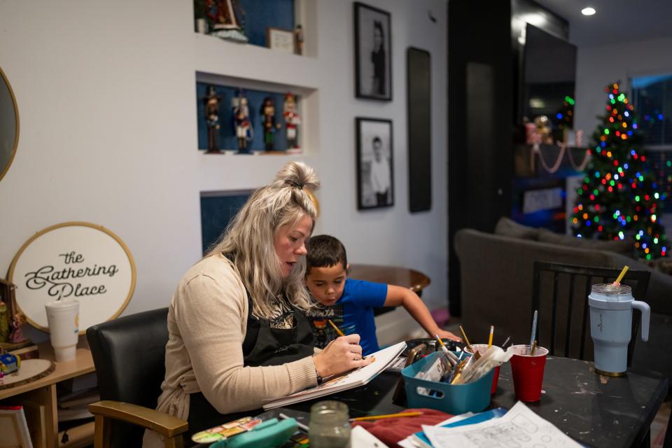 Jessica Palu shows her son “Bubba,” 4, a painting she’s working on at their home in Eagle Mountain on Tuesday, Nov. 28, 2023. | Spenser Heaps, Deseret News