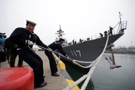 Japanese navy personnel moor the Japan Maritime Self-Defense Force destroyer JS Suzutsuki (DD 117) at Qingdao Port for the 70th anniversary of the founding of the Chinese People's Liberation Army Navy (PLAN), in Qingdao, China, April 21, 2019. REUTERS/Jason Lee