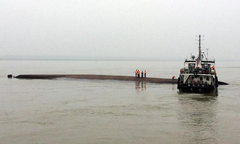 A Chinese rescue boat is seen alongside a capsized passenger ship carrying more than 450 people which sunk in the Yangtze river, Hubei province, on June 2, 2015