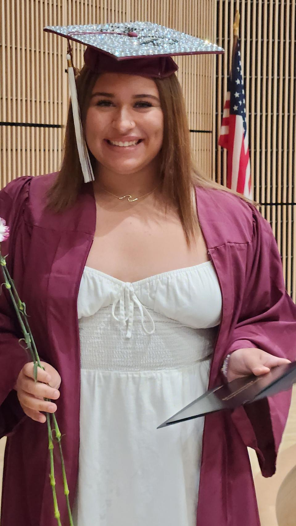 One of the essay winners at the over Adult Learning Center graduation on June 20, 2023, Jennica Robidoux accepts her award.