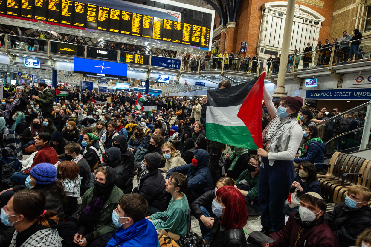 LONDON, ENGLAND - OCTOBER 31: Activists stage a mass sit down protest in Liverpool street station during rush hour to demand a ceasefire and humanitarian aid into Gaza on October 31, 2023 in London, England. (Photo by Guy Smallman/Getty Images)