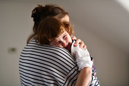 Maria, 31, holds her daughter Elena, who is two years and seven-months old, at their home in London, Britain, February 17, 2019. REUTERS/Alecsandra Dragoi
