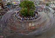 <p>Nepalese devotees pull a giant wooden chariot in a circle to celebrate Rato Machhindranath, the god of rain, during a festival in Lalitpur, near Kathmandu, Nepal, on May 17, 2016. The festival celebrates the hope of a good harvest, prosperity and good luck for the coming year. (Narendra Shrestha/EPA)<br></p>