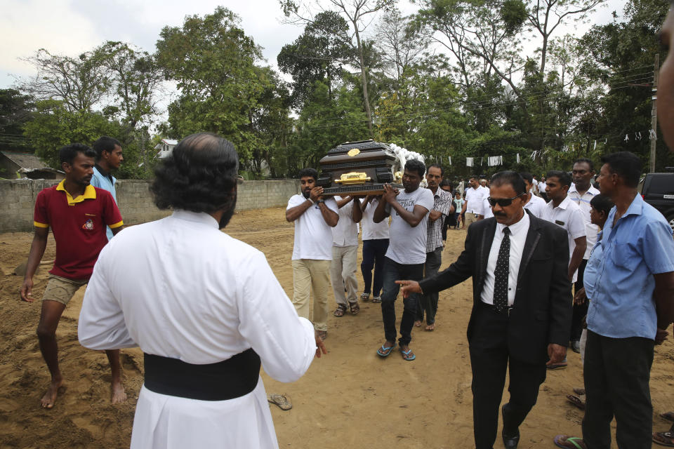 Relatives carry the coffin of a victim of Easter Sunday's bomb blast at St. Sebastian Church, in Negombo, Sri Lanka Thursday, April 25, 2019. The U.S. Embassy in Sri Lanka warned Thursday that places of worship could be targeted for militant attacks over the coming weekend, as police searched for more suspects in the Islamic State-claimed Easter suicide bombings that killed over 350 people. (AP Photo/Manish Swarup)