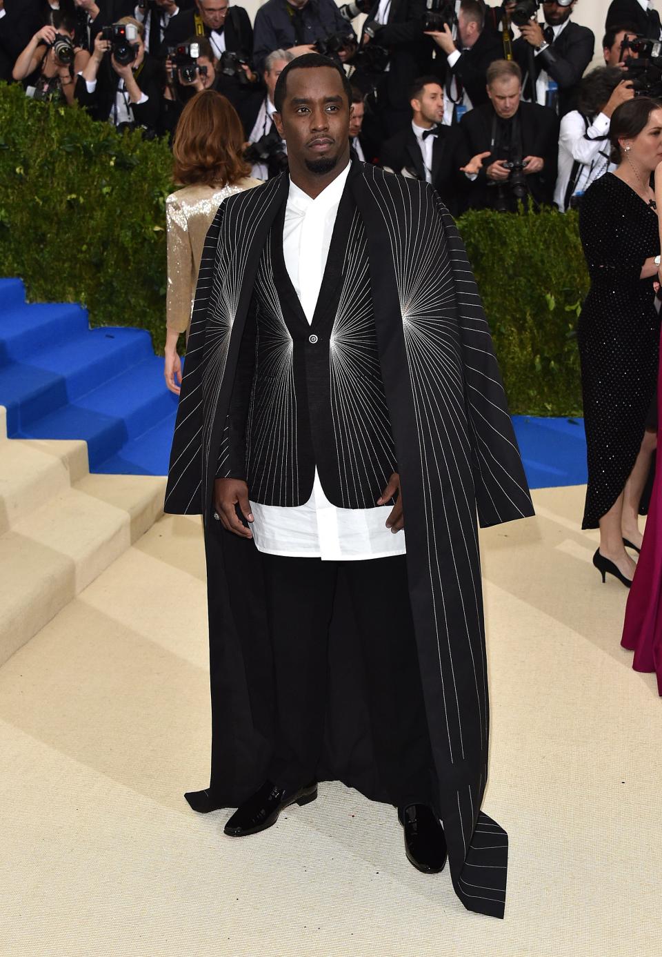 P. Diddy wears a suit with a cape to the 2017 Met Gala.