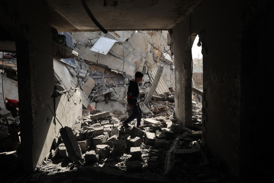 A Palestinian boy walks through the rubble following Israeli bombardment of Rafah's Tal al-Sultan district in the southern Gaza Strip on May 7, 2024. The Israeli army said it took 