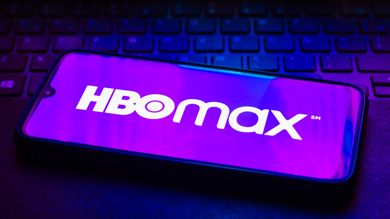  The HBO Max logo on a phone on top of a keyboard 