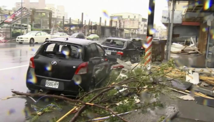 <p>In this image made from video, wind-blown debris from Typhoon Nepartak litters the street and damages a vehicle in Taitung, south eastern Taiwan, Friday, July 8, 2016. (EBC via AP Video) </p>
