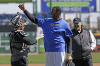 Retired NBA All-Star Tracy McGrady, center, gives a thumbs up as Sugar Land Skeeters catcher Koby Clemens, left, tries to hand him the ball and manager Gary Gaetti smiles at the Skeeters' baseball stadium Wednesday, Feb. 12, 2014, in Sugar Land, Texas. McGrady hopes to try out as a pitcher for the independent Atlantic League Skeeters. (AP Photo/Pat Sullivan)