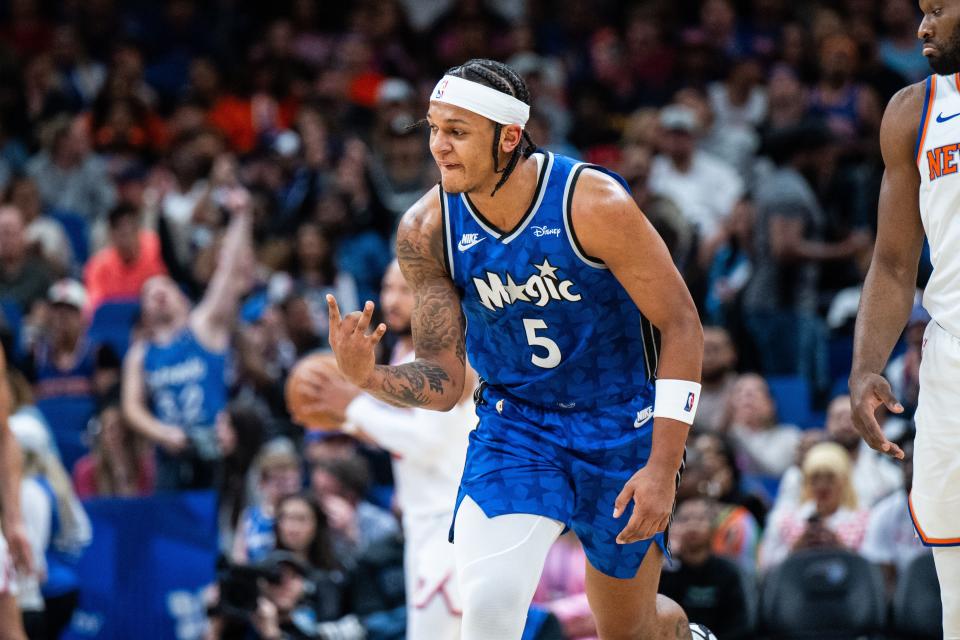 Feb 14, 2024; Orlando, Florida, USA; Orlando Magic forward Paolo Banchero (5) celebrates a three-point shot against the New York Knicks in the second quarter at KIA Center. Mandatory Credit: Jeremy Reper-USA TODAY Sports