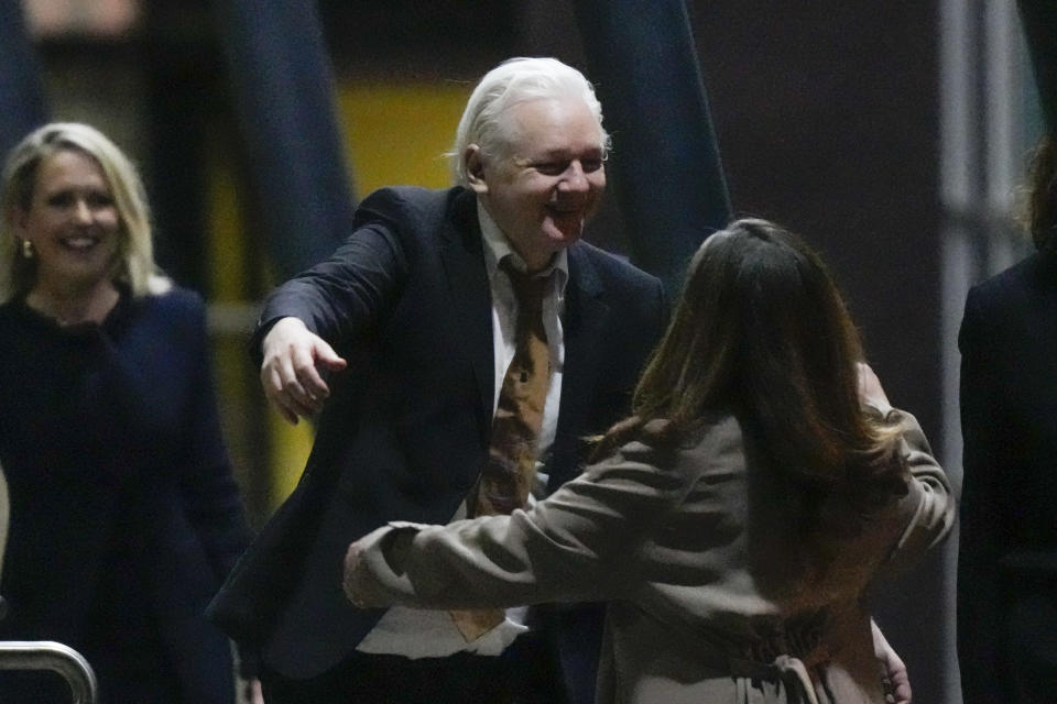 WikiLeaks founder Julian Assange embraces his wife Stella after landing at RAAF air base Fairbairn in Canberra, Australia, Wednesday, June 26 2024. Assange has returned to his homeland Australia aboard a charter jet hours after pleading guilty to obtaining and publishing U.S. military secrets in a deal with Justice Department prosecutors that concludes a drawn-out legal saga.(AP Photo/Rick Rycroft)