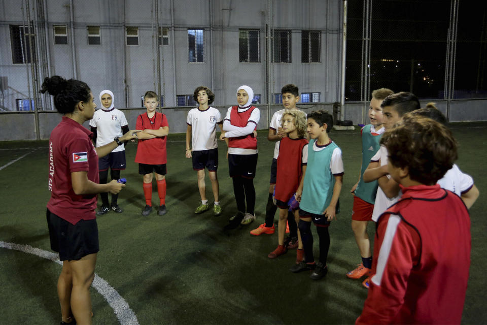 Insherah Heyasat, a football player, gives instructions during a training of the Orthodox Club's women's team in Amman, Jordan, Saturday, Oct. 22, 2022. Women's soccer has been long been neglected in the Middle East, a region that is mad for the men's game and hosts the World Cup for the first time this month in Qatar. (AP Photo/Raad AL-Adayleh)
