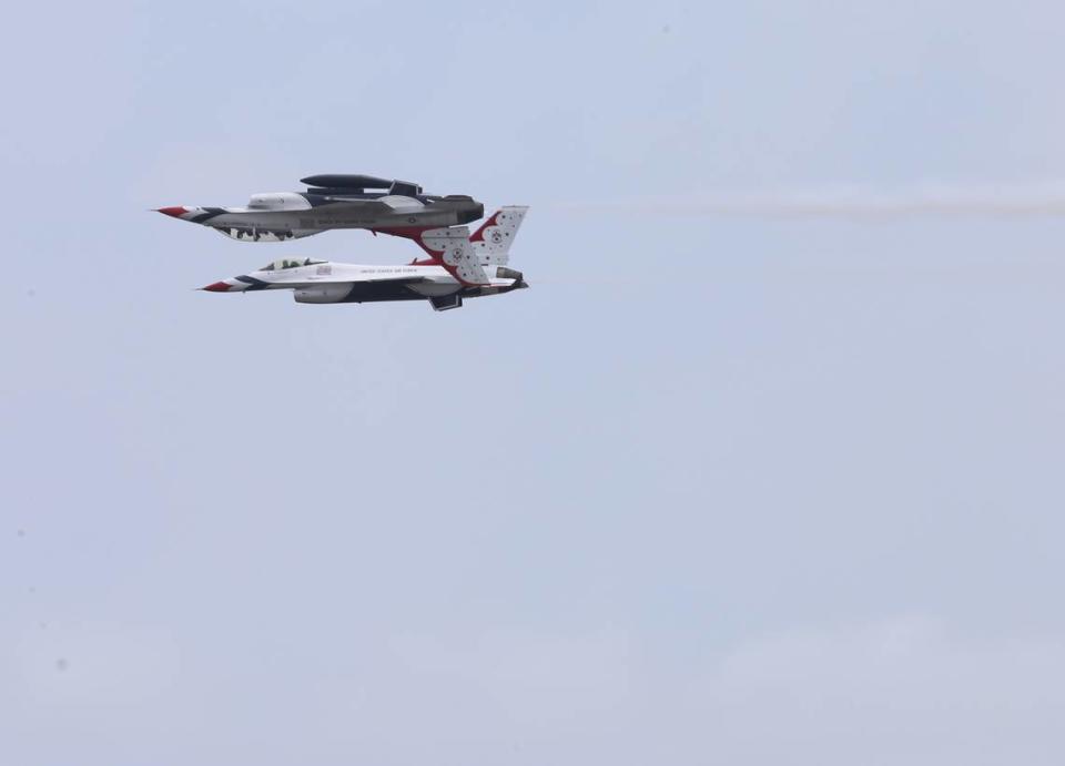 Two of the U.S. Air Force Thunderbirds execute a difficult maneuver where the jets fly side-by-side with one flying upside down.