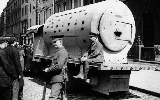 British soldiers guard an improvised armoured car made from a locomotive boiler and used to convey troops from point to point during the 'Easter Rising'   - Credit: PA/EMPICS