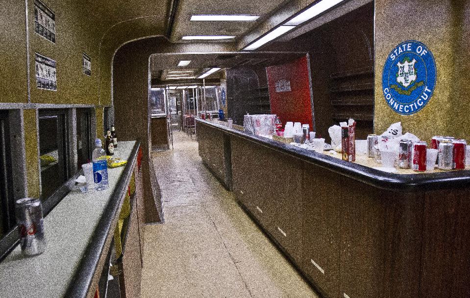 The bar car on the 7:07 p.m. train from Grand Central Terminal in New York to New Haven, Conn., is empty of riders after its run on Thursday, May 8, 2014. The bar car is near the end of its run as Metro-North is retiring it from the New Haven Line after Friday's afternoon rush hour. The cars were a fixture on Metro-North Railroad trains for at least a half century. For some riders, they were more than a place to have a drink on the long ride home from work. Commuters played dice, formed friendships, talked business, pulled pranks and even had Christmas parties with a jazz band. (AP Photo/Michael R. Sisak)