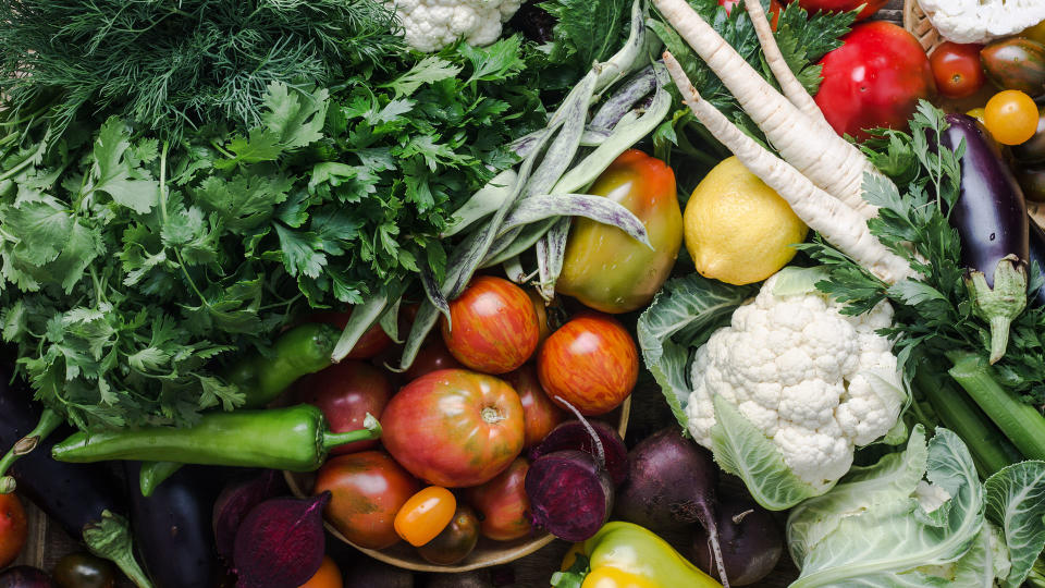 colorful fruits and vegetables arranged on a table, part of a plant-based diet