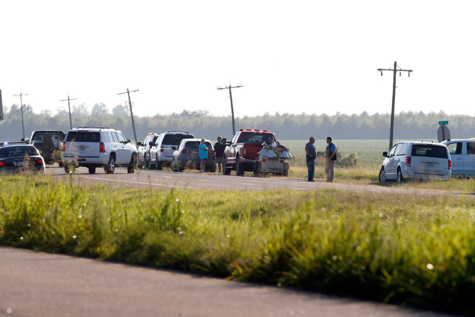 <p>Emergency personnel stand along U.S. Highway 82 after a military transport plane crashed into a field near Itta Bena, Miss., on the western edge of Leflore County, Monday, July 10, 2017. (Photo: Andy Lo/AP) </p>