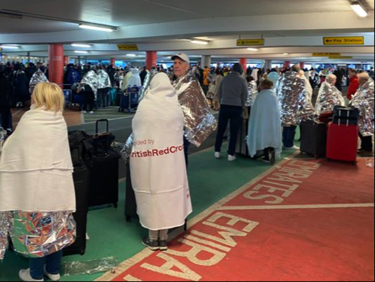 Cold comfort: Passengers waiting in the car park outside Glasgow airport (Andy Murdoch)