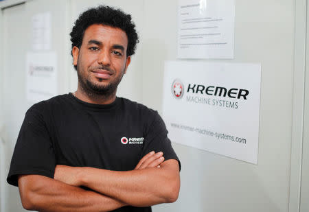 Merhawi Tesfay, an immigrant from Eritrea poses during a Reuters interview at German plant engineering firm Kremer Machine Systems where he found a job as electrician and plant manufacturer in Gescher near Muenster, Germany, August 4, 2017. REUTERS/Wolfgang Rattay