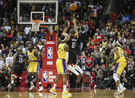 Jan 19, 2019; Houston, TX, USA; Houston Rockets guard Eric Gordon (10) makes a three point basket as Los Angeles Lakers guard Kentavious Caldwell-Pope (1) defends during the fourth quarter at Toyota Center. Mandatory Credit: Troy Taormina-USA TODAY Sports