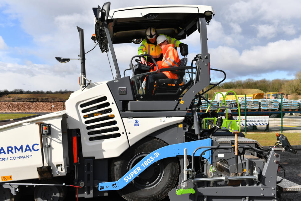 The Duke of Cambridge (left) operating an asphalt paver during a visit to the Tarmac National Skills and Safety Park in Nottinghamshire.