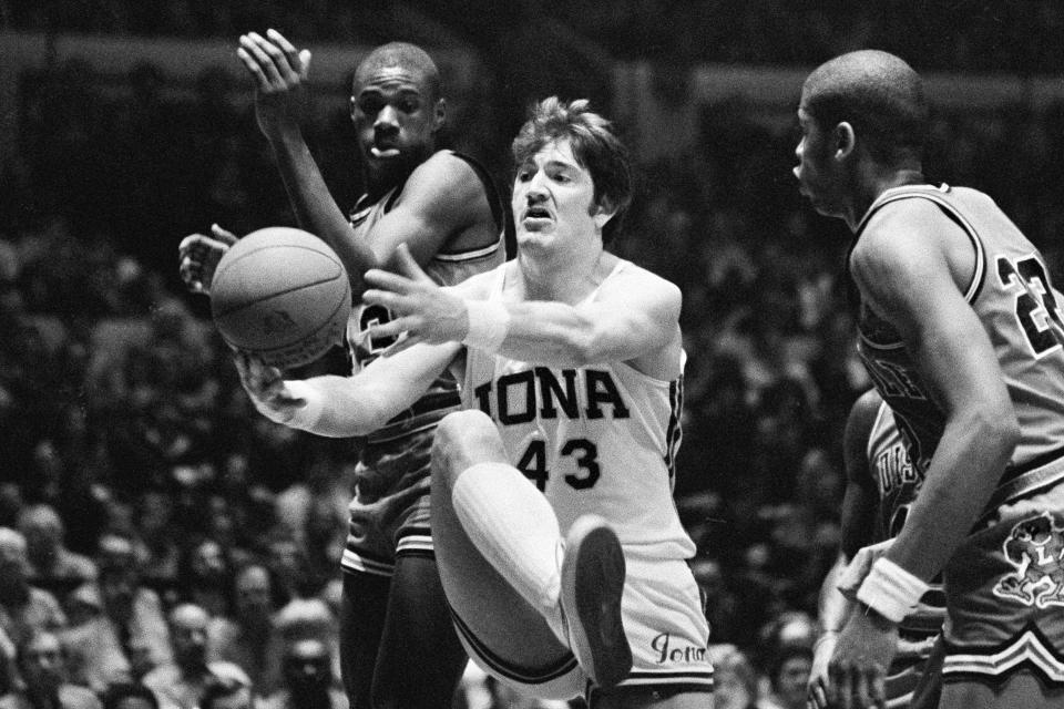 FILE - Iona's Jeff Ruland (43, cuts off Louisville's Derek Smith, left, to grab an offensive rebound in the second half of an NCAA college basketball game at Madison Square Garden in New York, Feb. 21, 1980. The marquee win over Louisville and a 29-win season earned Iona its first ranking in the AP Top 25 at No. 19 in the final poll of the 1979-80 season. It also turned about to be the Gaels' last, (AP Photo/Ray Stubblebine, File)