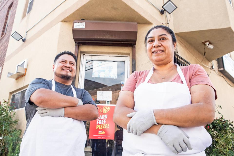 Chef Valentin Palillero and his wife, Eva Mendez, stand at the front door of San Lucas Pizzeria, the restaurant they own since 2005, in Philadelphia, Tuesday, Sept. 19, 2023. Paillero is the first chef known to have made a specialty out of Mexican pizza in South Philly.