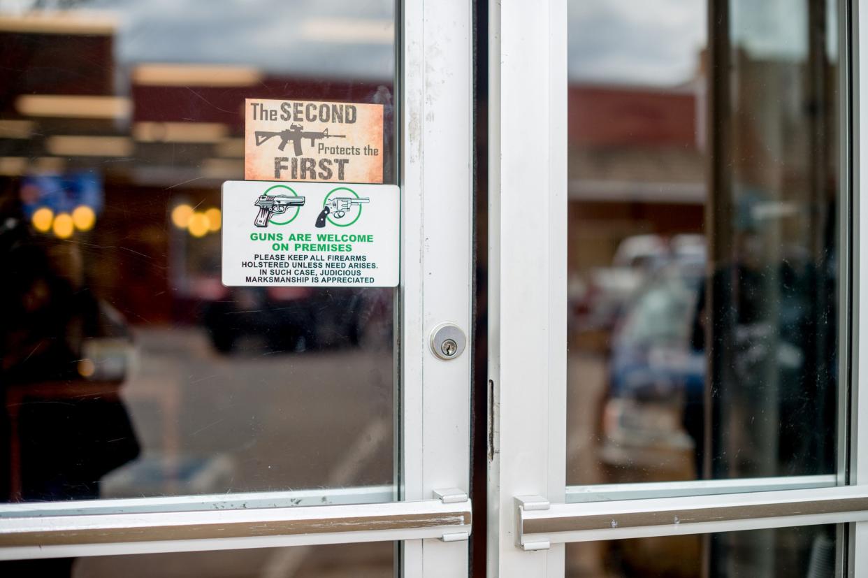 Signs on the door handles at Shooters Grill in Rifle on April 24, 2018.