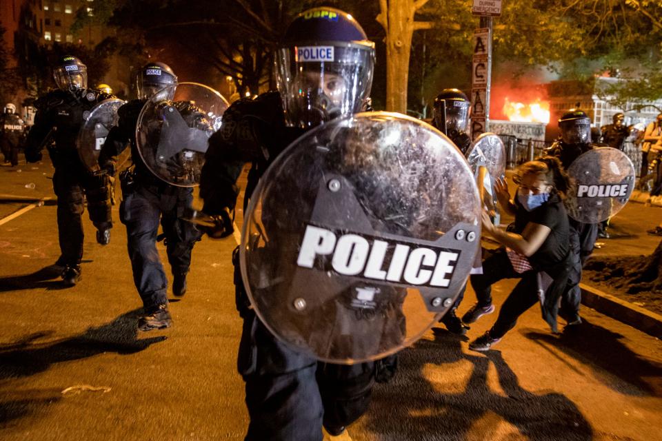 An officer charges forward on May 31, 2020, in front of the White House as people protest the death of George Floyd at the hands of Minneapolis police. 