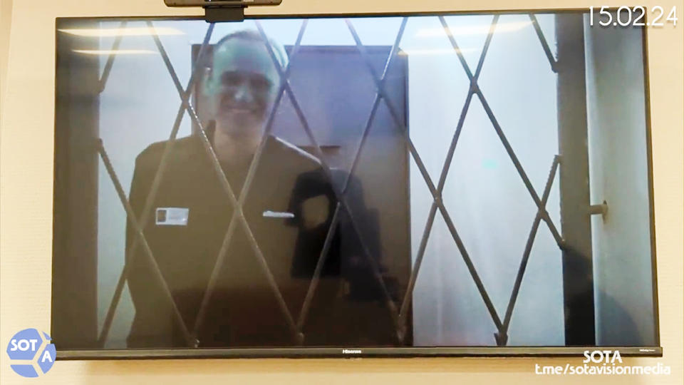 FILE This photo taken from video released by Russian Federal Penitentiary Service via SOTAVISION shows Russian opposition leader Alexei Navalny appears via a video link from the Arctic penal colony in Kharp, in the Yamalo-Nenetsk region about 1,900 kilometers (1,200 miles) northeast of Moscow, where he is serving a 19-year sentence, in Kovrov, Russia, on Feb. 15, 2024. Shortly after Navalny's death was reported on Friday Feb. 16, 2024, the Russian SOTA social media channel shared images of the opposition politician reportedly in court yesterday. In the footage, Navalny is seen standing up and is laughing and joking with the judge via video link. (Russian Federal Penitentiary Service via SOTAVISION via AP, File)