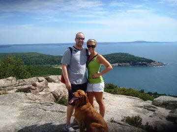 Alec and Heather Cyr at Acadia National Park in Maine with their golden retriever, Mollie, in 2010, a year before Alec died of colon cancer at age 35.