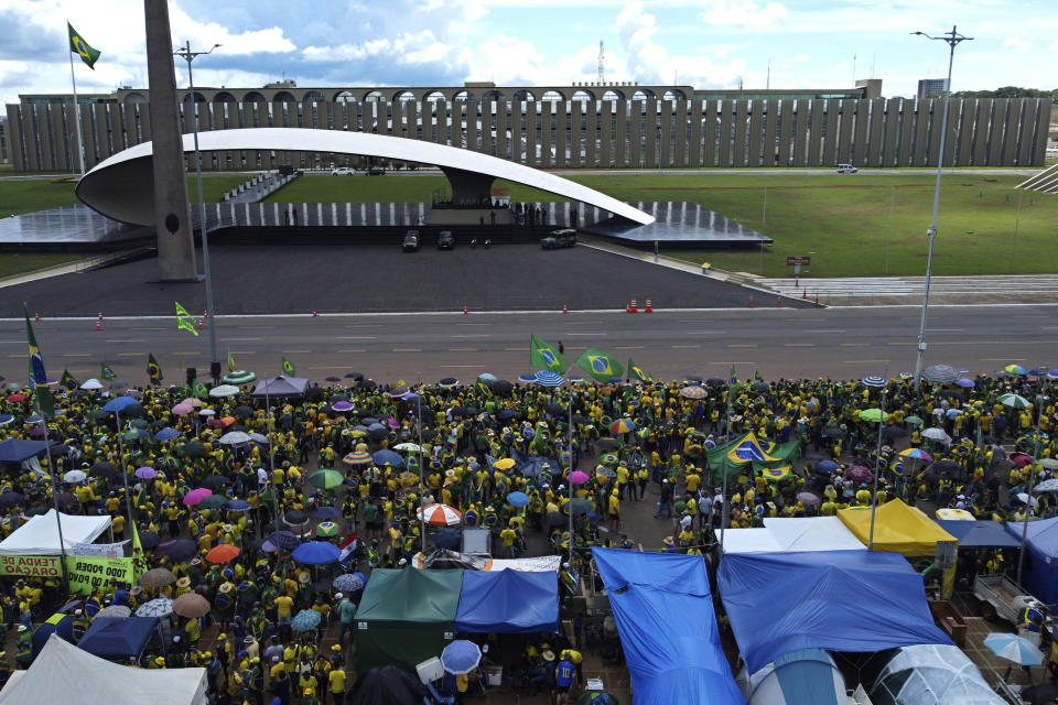 FILE - Supporters of Brazilian President Jair Bolsonaro protest against Bolsonaro's run-off election loss outside the Army headquarters in Brasilia, Brazil, Nov. 15, 2022. Many reject results of the vote and remain camped outside military buildings nationwide, demanding that Luiz Inácio Lula da Silva's inauguration will be impeded. (AP Photo/Eraldo Peres, File)