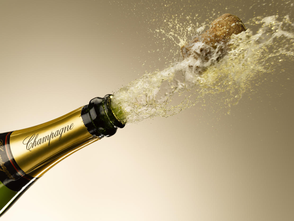 Champagne and cork exploding from bottle