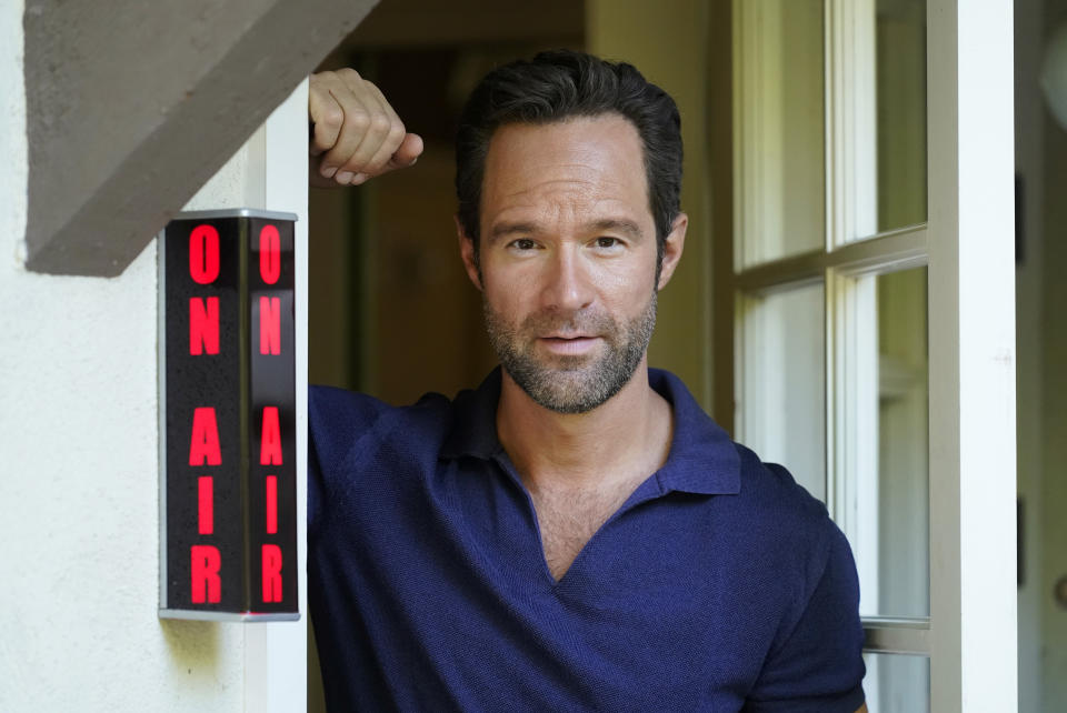 Actor and voiceover artist Chris Diamantopoulos poses for a portrait at his home studio in Los Angeles on Nov. 5, 2021. Diamantopoulos stars in the Netflix film "Red Notice." (AP Photo/Chris Pizzello)