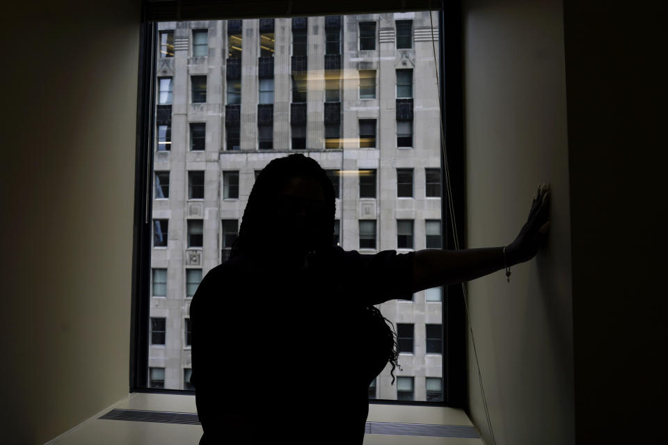 In this Sept. 23, 2021, photo Domonique Wilson poses for a photo at her attorney's office in Chicago. Wilson’s son Royal Smart was handcuffed by police in south Chicago during a raid on his home when he was 8-years-old. Police were looking for illegal weapons and found none. No one was arrested. Wilson, said her children still sleep with the lights on all night. They continue to try therapy but she said the memories still torment them. (AP Photo/Nam Y. Huh)