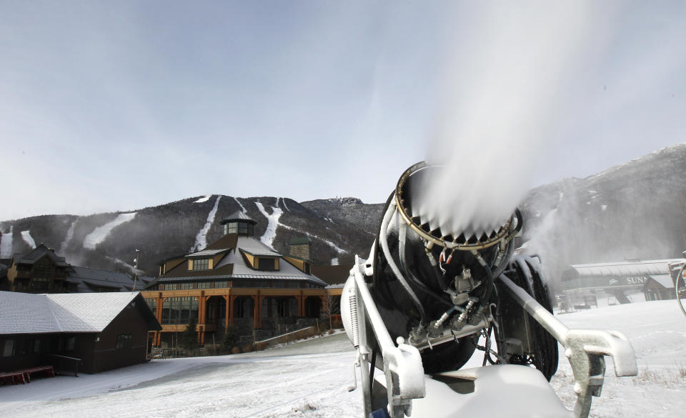 This Nov. 15, 2012 photo shows a snow gun making fresh snow at the Stowe resort in Stowe, Vt. The ground might be bare, but ski areas across the Northeast are making big investments in high-efficiency snowmaking so they can open more terrain earlier and longer. (AP Photo/Toby Talbot)