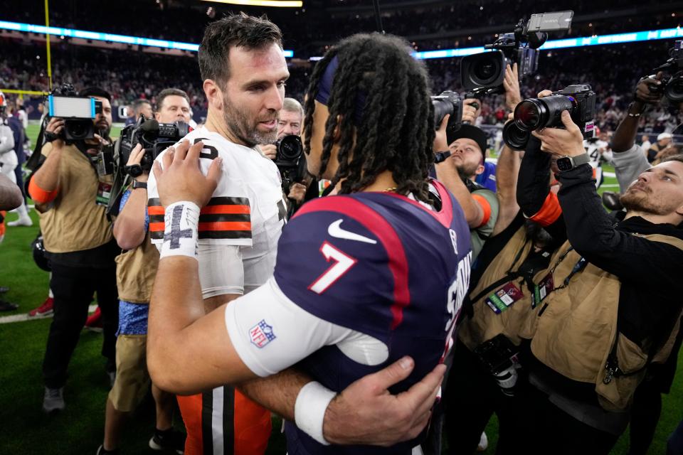 Houston Texans quarterback C.J. Stroud and Cleveland Browns quarterback Joe Flacco meet on the field after a win by Houston in a wild-card playoff game Saturday in Houston.