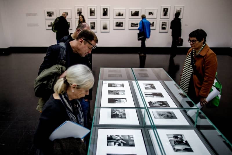 Guests walk through the exhibition of works by German photographer Helga Paris during a preview. The photographer Helga Paris, who grew up in the former East Berlin and became known for vividly capturing everyday life in the Soviet zone, has died at the age of 85.Paris died on 05 February at her flat in the German capital, her daughter told dpa on 06 February. Carsten Koall/dpa