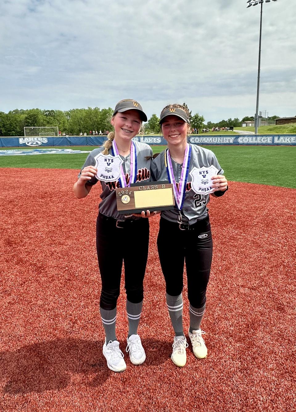 Wellsville's softball sisters Teagan, left, and Sawyer Burke with the Section V Class B championship brick.